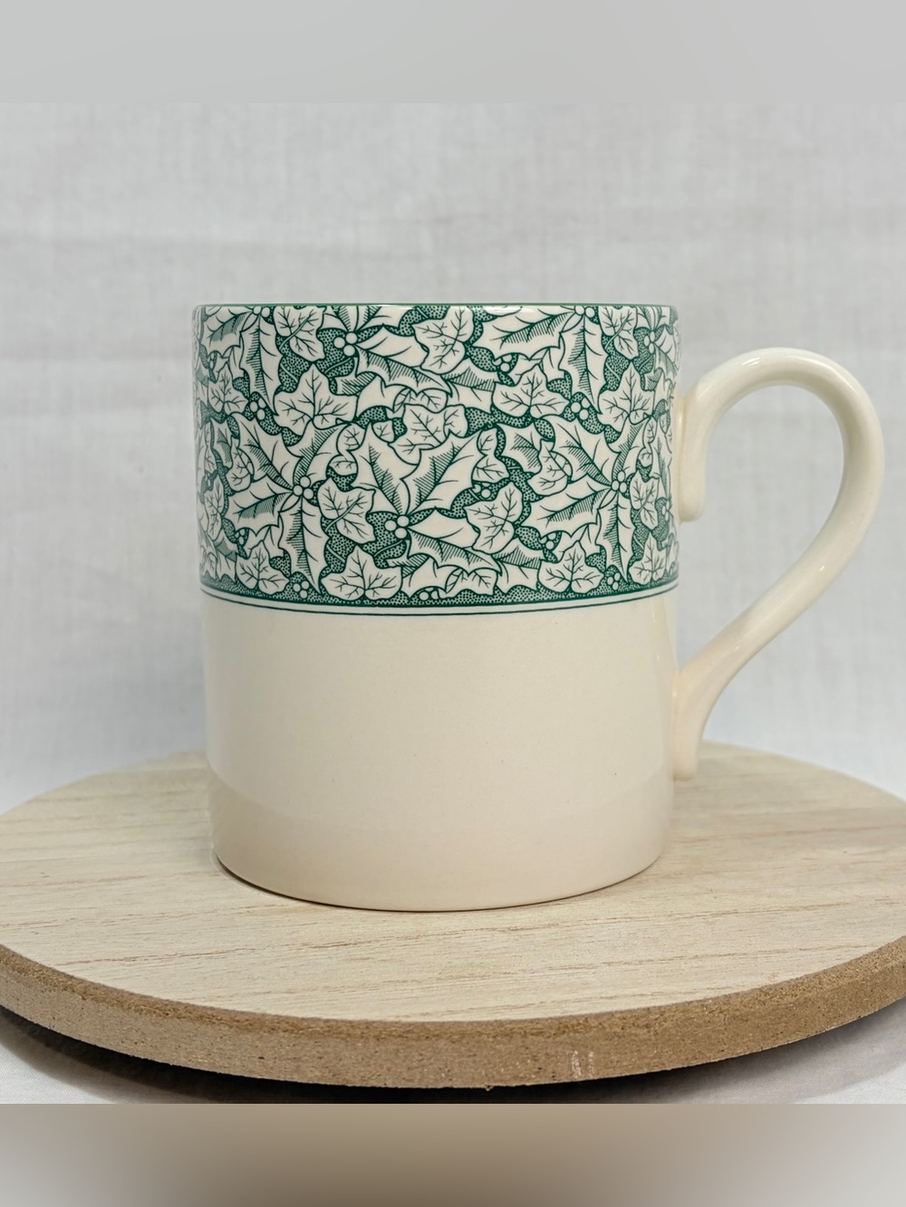 Spode Holly Tree mug features a green holly pattern on a white background